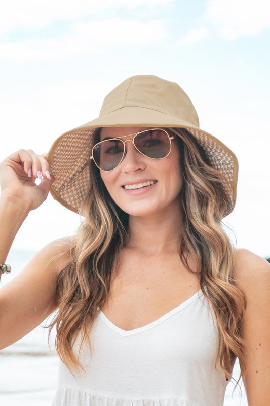 Woman wearing a wide-brimmed Bow Accent Cargo Hat at the beach.