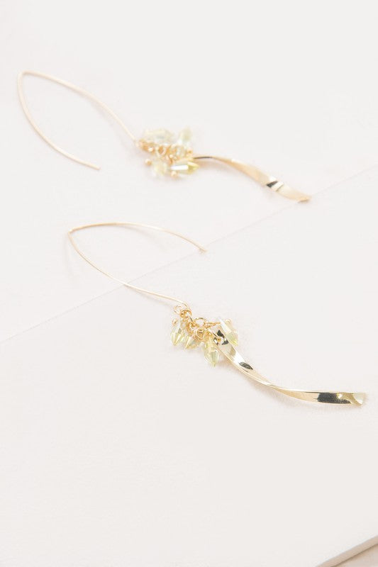 The Twist Arc Threader Earrings boast a graceful design with a curved shape and delicate crystal accents.