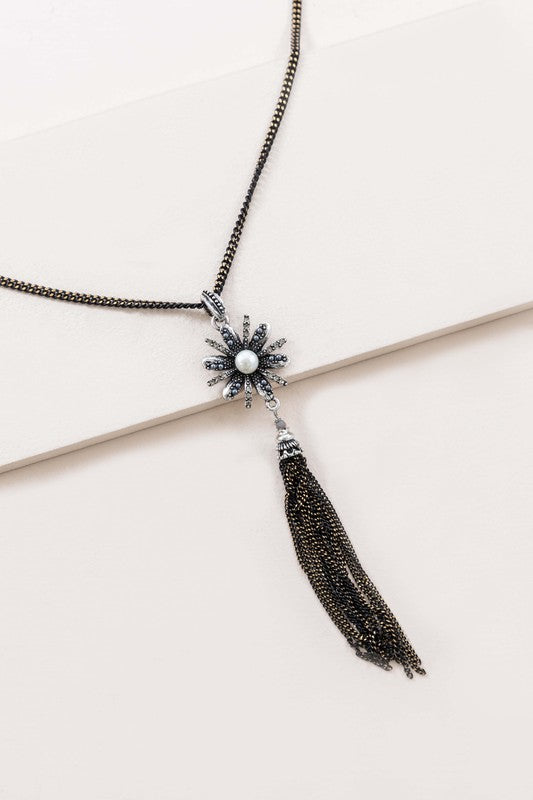 A Trieste Tassel Necklace with a starburst design and tassel detailing displayed on a light background.