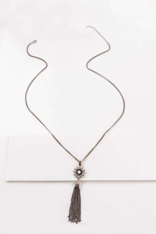 A Trieste Tassel Necklace with a starburst design and tassel detailing displayed on a light background.