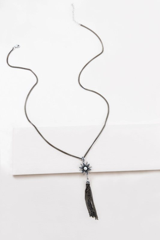 A Trieste Tassel Necklace with a starburst design and tassel detailing displayed on a light background.