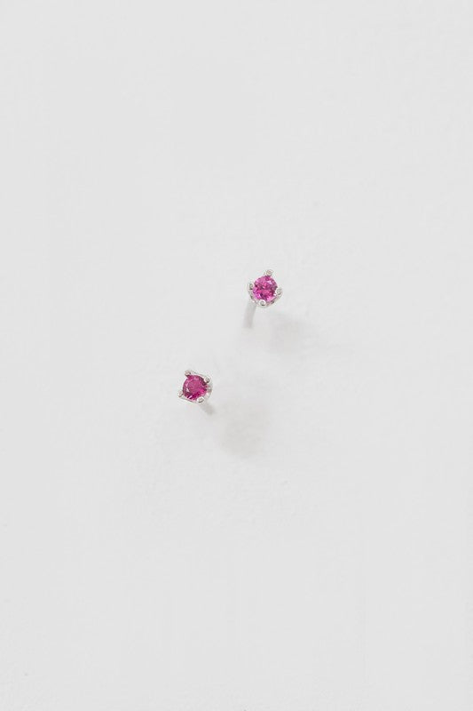 A collection of six pairs of Dainty Stud Stone Earrings displayed on a white background, showcasing hypoallergenic designs with sterling silver accents, adorned with stones in blue, pink, and clear hues.