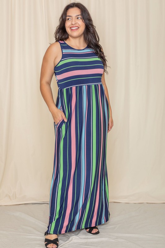 Someone is standing against a light-colored backdrop, wearing the Multi Stripe Rainbow Maxi Dress, a sleeveless garment featuring vertical stripes in shades of blue, green, pink, and purple.