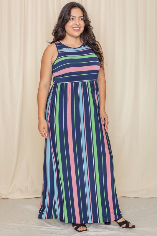 Someone is standing against a light-colored backdrop, wearing the Multi Stripe Rainbow Maxi Dress, a sleeveless garment featuring vertical stripes in shades of blue, green, pink, and purple.