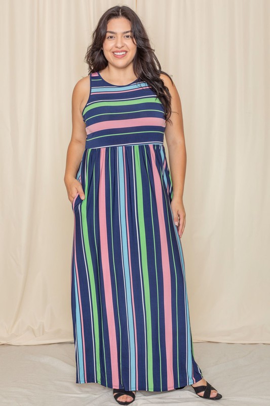 Someone is standing against a light-colored backdrop, wearing the Multi Stripe Rainbow Maxi Dress, a sleeveless garment featuring vertical stripes in shades of blue, green, pink, and purple.