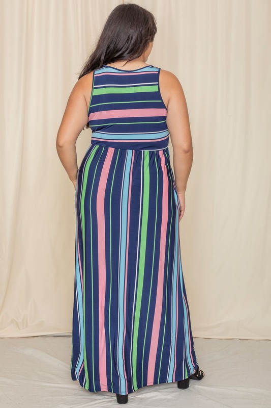 Someone is standing against a light-colored backdrop, wearing the Multi Stripe Rainbow Maxi Dress, a sleeveless garment featuring vertical stripes in shades of blue, green, pink, and purple.