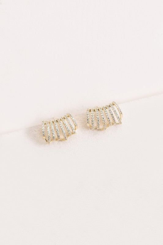 Armored Curved Huggie Hoop Earrings with embedded rhinestones on a white background.