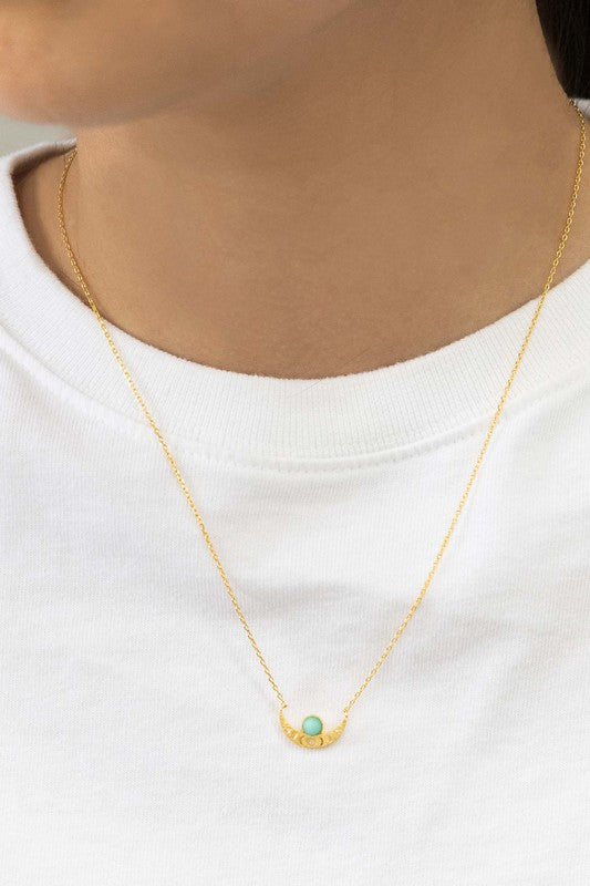 The Rumi Stone Necklace collection showcases five Bohemian-style stone and gold necklaces with crescent-shaped pendants, each adorned with a uniquely colored stone, beautifully displayed on a white background.