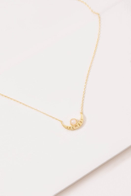 The Rumi Stone Necklace collection showcases five Bohemian-style stone and gold necklaces with crescent-shaped pendants, each adorned with a uniquely colored stone, beautifully displayed on a white background.