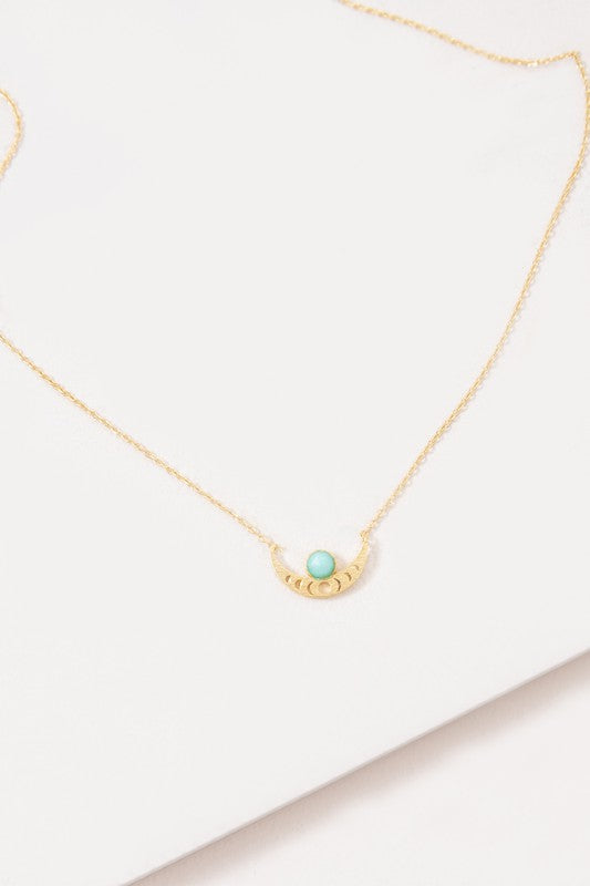 The Rumi Stone Necklace collection showcases five Bohemian-style stone and gold necklaces with crescent-shaped pendants, each adorned with a uniquely colored stone, beautifully displayed on a white background.