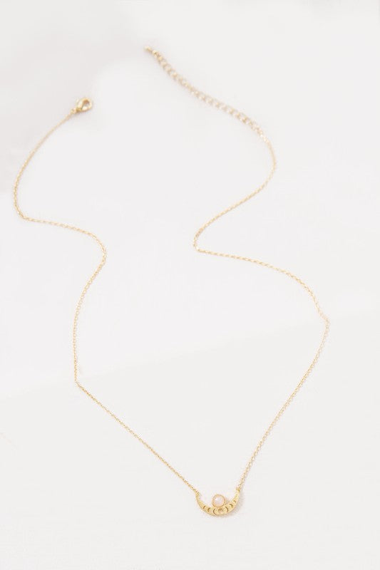 The Rumi Stone Necklace collection showcases five Bohemian-style stone and gold necklaces with crescent-shaped pendants, each adorned with a uniquely colored stone, beautifully displayed on a white background.