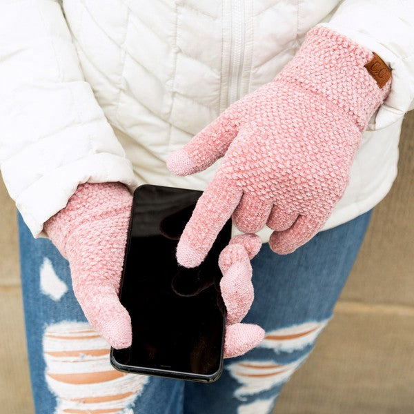 A person wearing a white jacket and gray CC Chenille Touch Gloves using a smartphone.