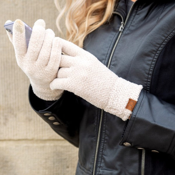 A person wearing a white jacket and gray CC Chenille Touch Gloves using a smartphone.