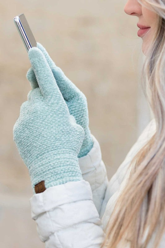 A person wearing a white jacket and gray CC Chenille Touch Gloves using a smartphone.