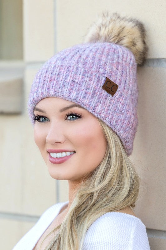 Woman smiling while wearing a CC Cozy Marled Pom Beanie.