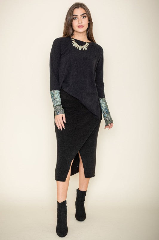 Person wearing a Knit Side Slit Paisley Cuff Tunic with jeans, standing against a plain background.