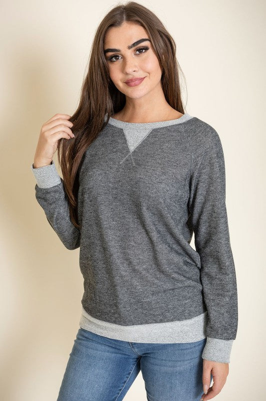 Person wearing the Terry Crew Neck Tunic in gray with light gray cuffs and neckline, made in the United States, standing against a neutral background.