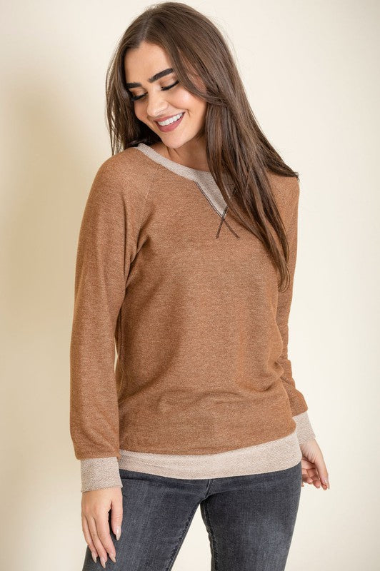 Person wearing the Terry Crew Neck Tunic in gray with light gray cuffs and neckline, made in the United States, standing against a neutral background.