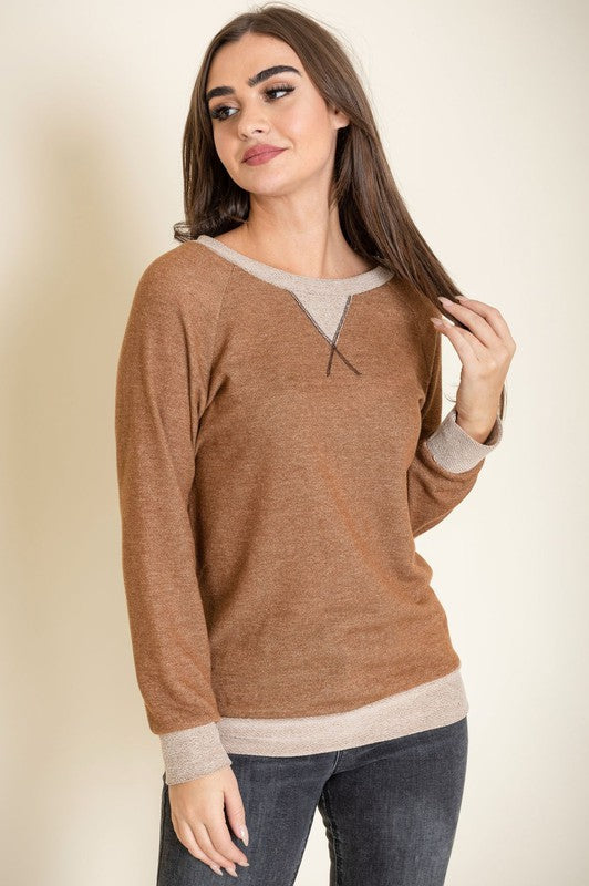 Person wearing the Terry Crew Neck Tunic in gray with light gray cuffs and neckline, made in the United States, standing against a neutral background.