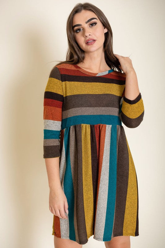 A woman stands against a plain background wearing the Multi Color Mini Dress, crafted from a comfortable blend of polyester and spandex.