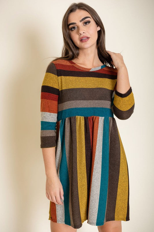 A woman is wearing the Multi Color Mini Dress, crafted from polyester spandex with long sleeves. She is looking off to the left. Made in the United States.