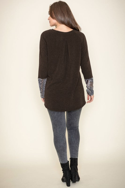 Person wearing a Knit Side Slit Paisley Cuff Tunic with jeans, standing against a plain background.