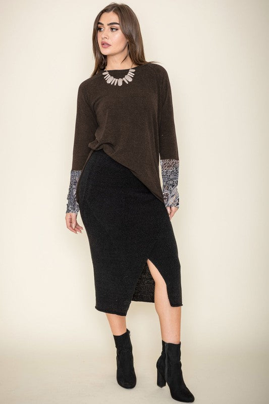 Person wearing a Knit Side Slit Paisley Cuff Tunic with jeans, standing against a plain background.