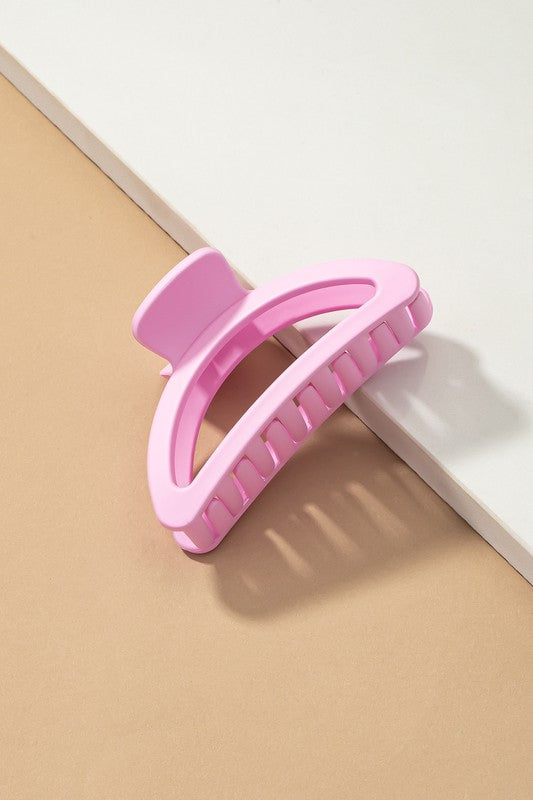 Five Iridescent Crescent Shape Big Claw Hair Clips, featuring the delicate tones of a Morandi color palette, are displayed on a beige surface with a white rectangular strip.