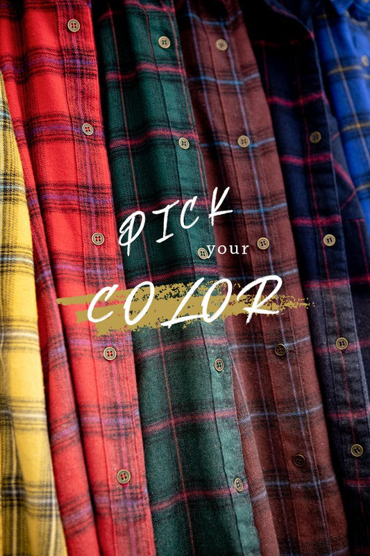 A woman wearing a vintage green Kayla Shirt over a white tank top, blue denim shorts, and a red cap stands against a plain background.