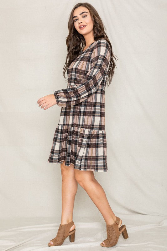 A person is wearing the Plaid Balloon Sleeve Tiered Midi Dress in red, yellow, and white, standing against a light background.