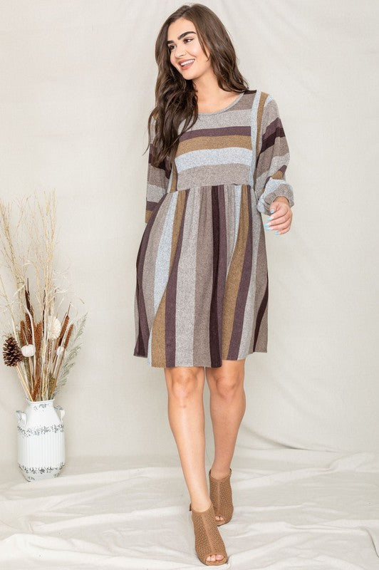 A woman with long hair poses in a Mix Stripe Balloon Sleeve Midi Dress against a plain background.