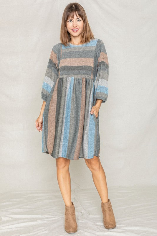 A woman with long hair poses in a Mix Stripe Balloon Sleeve Midi Dress against a plain background.