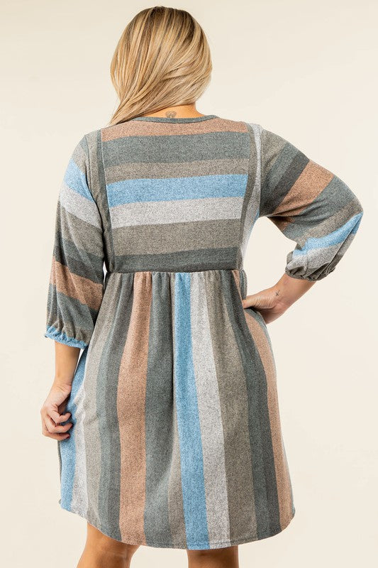 A person stands smiling, dressed in a Mix Stripe Balloon Sleeve Midi Dress that features multi-colored horizontal stripes in shades of blue, brown, and gray. The midi dress, crafted from polyester, includes three-quarter sleeves and handy pockets.