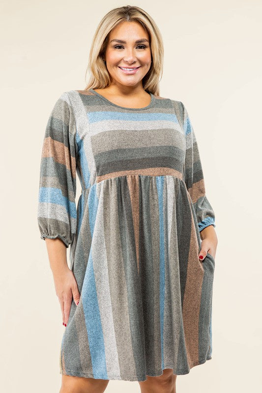 A person stands smiling, dressed in a Mix Stripe Balloon Sleeve Midi Dress that features multi-colored horizontal stripes in shades of blue, brown, and gray. The midi dress, crafted from polyester, includes three-quarter sleeves and handy pockets.