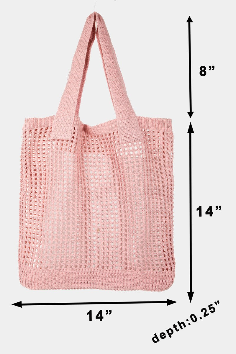 The Fame Pointelle Knit Crochet Tote Bag, available in a trendy light pink color, boasts a stylish open mesh pattern and two parallel shoulder straps, making it the perfect accessory for modern fashion.