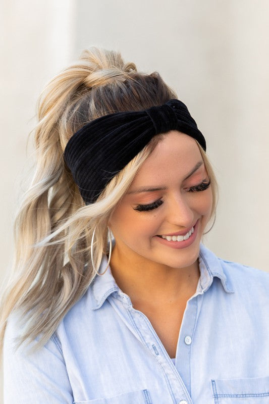 A smiling woman with blond hair wearing a blue shirt and an Adjustable, High-Quality Stretch Corduroy Headwrap.