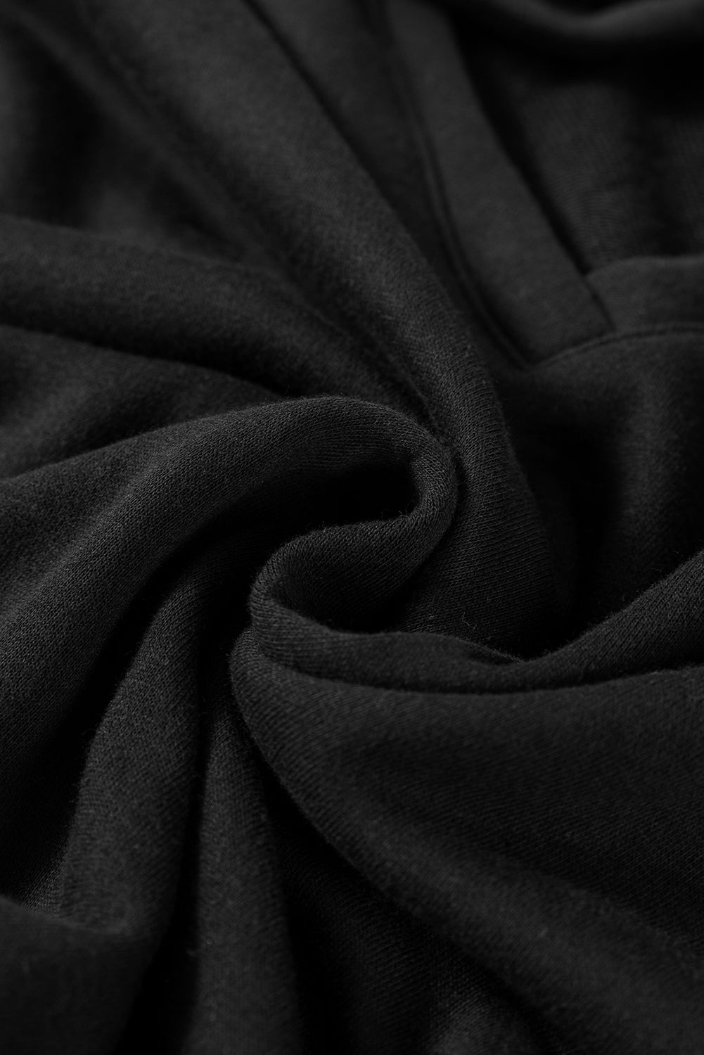 A person wearing a Black Bowknot Dewback Round Neck Sweatshirt, white pants, and a light-colored cap stands against a pink background. The individual has one hand on their hip and is looking down.