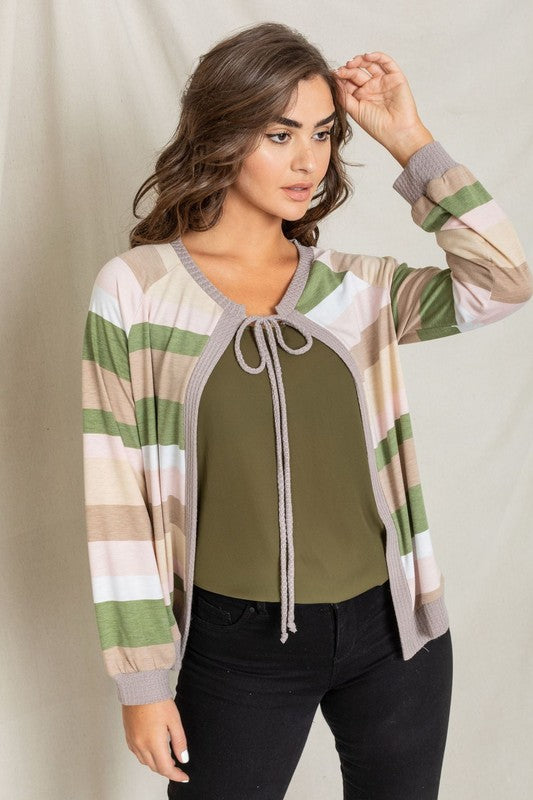 A person wearing the Multi Color Stripe Waffle Trim Open Cardigan over a green top and black pants stands against a light background.