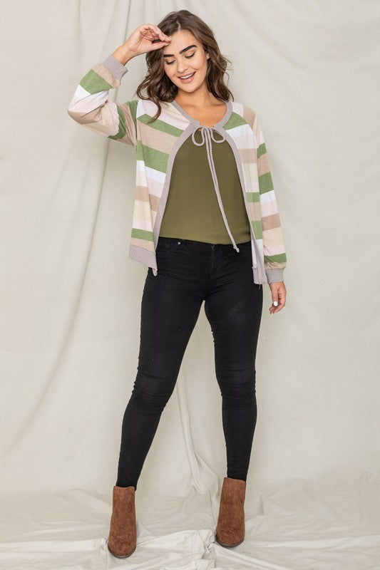 A person wearing the Multi Color Stripe Waffle Trim Open Cardigan over a green top and black pants stands against a light background.