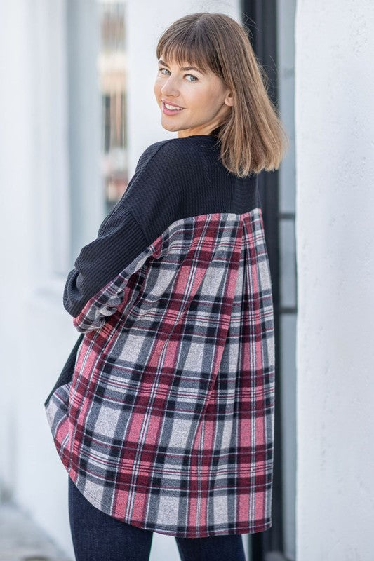 A woman models the Plaid Back Waffle Knit Cardigan paired with black pants, standing against a light background.