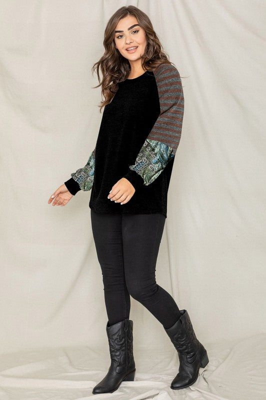 A woman wearing the Terry Stripe Bishop Sleeve Tunic in brown stands against a plain backdrop, looking to her right.