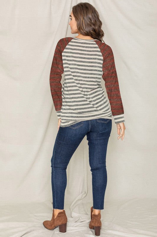 A person with shoulder-length hair is wearing a Two Tone Terry Stripe Tunic and jeans, standing in front of a plain background.