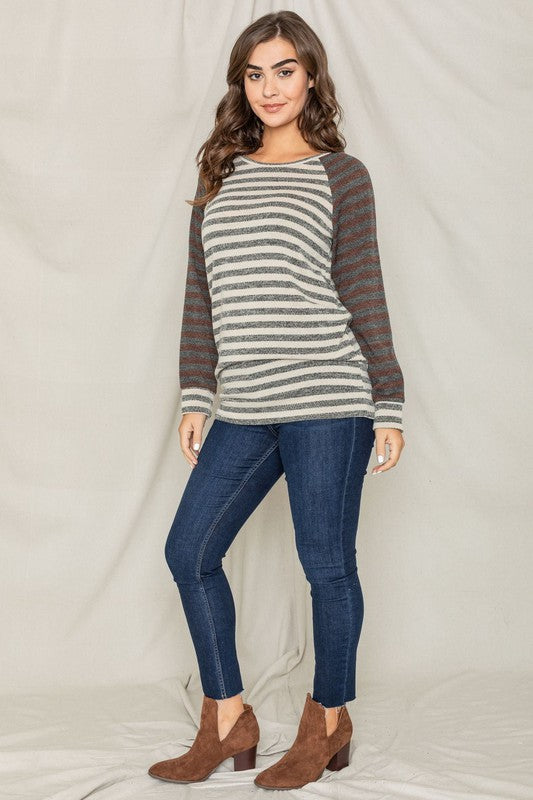 A person with shoulder-length hair is wearing a Two Tone Terry Stripe Tunic and jeans, standing in front of a plain background.