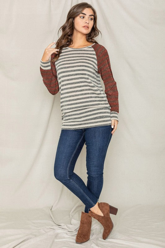 A person with shoulder-length hair is wearing a Two Tone Terry Stripe Tunic and jeans, standing in front of a plain background.