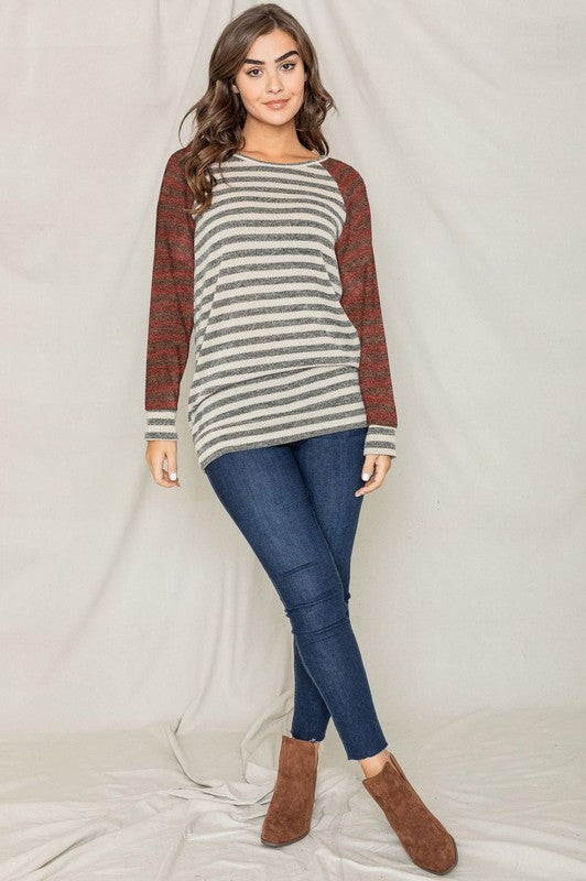 A person with shoulder-length hair is wearing a Two Tone Terry Stripe Tunic and jeans, standing in front of a plain background.