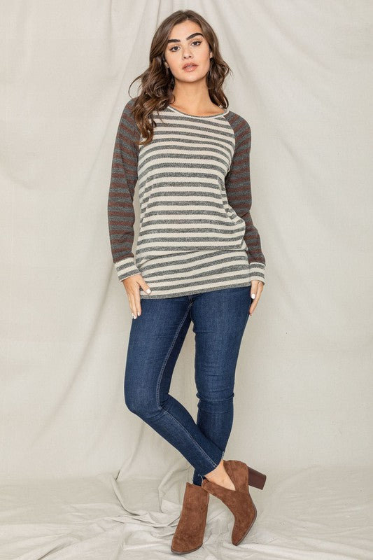 A person with shoulder-length hair is wearing a Two Tone Terry Stripe Tunic and jeans, standing in front of a plain background.