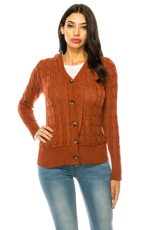 Person wearing a "Knit Sweater Plus Size" in teal with wooden buttons over a white top and blue high-waisted jeans.