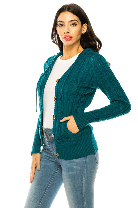 Person wearing a "Knit Sweater Plus Size" in teal with wooden buttons over a white top and blue high-waisted jeans.