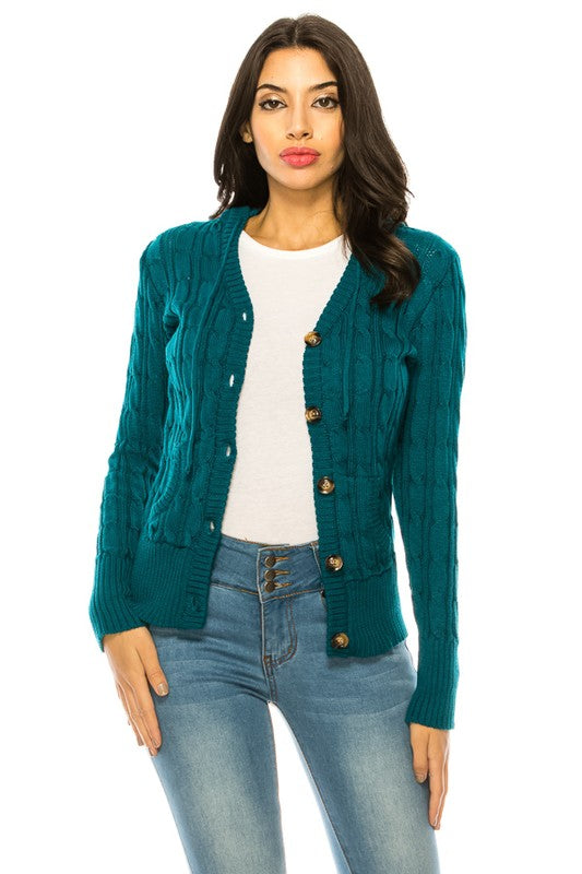 Person wearing a "Knit Sweater Plus Size" in teal with wooden buttons over a white top and blue high-waisted jeans.