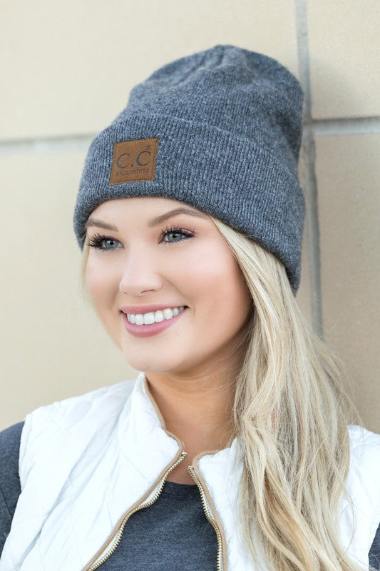 Woman smiling while wearing a CC Heathered Boyfriend Beanie.